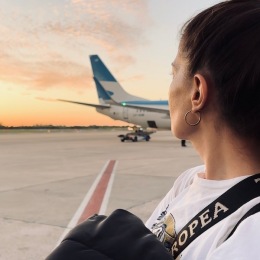 a woman looking at a plane
