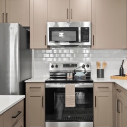 a kitchen with tan cabinets
