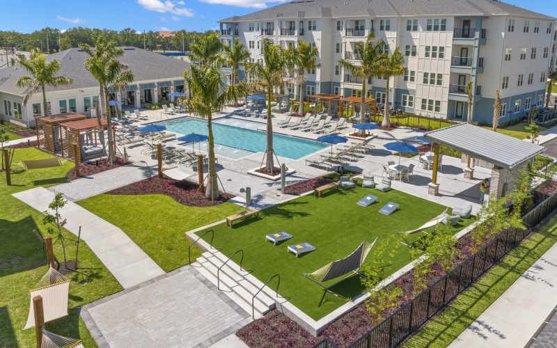 a courtyard with palm trees and a swimming pool